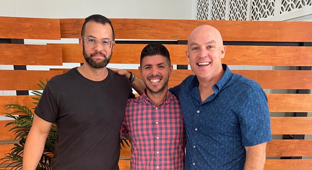 Three men smiling together at church