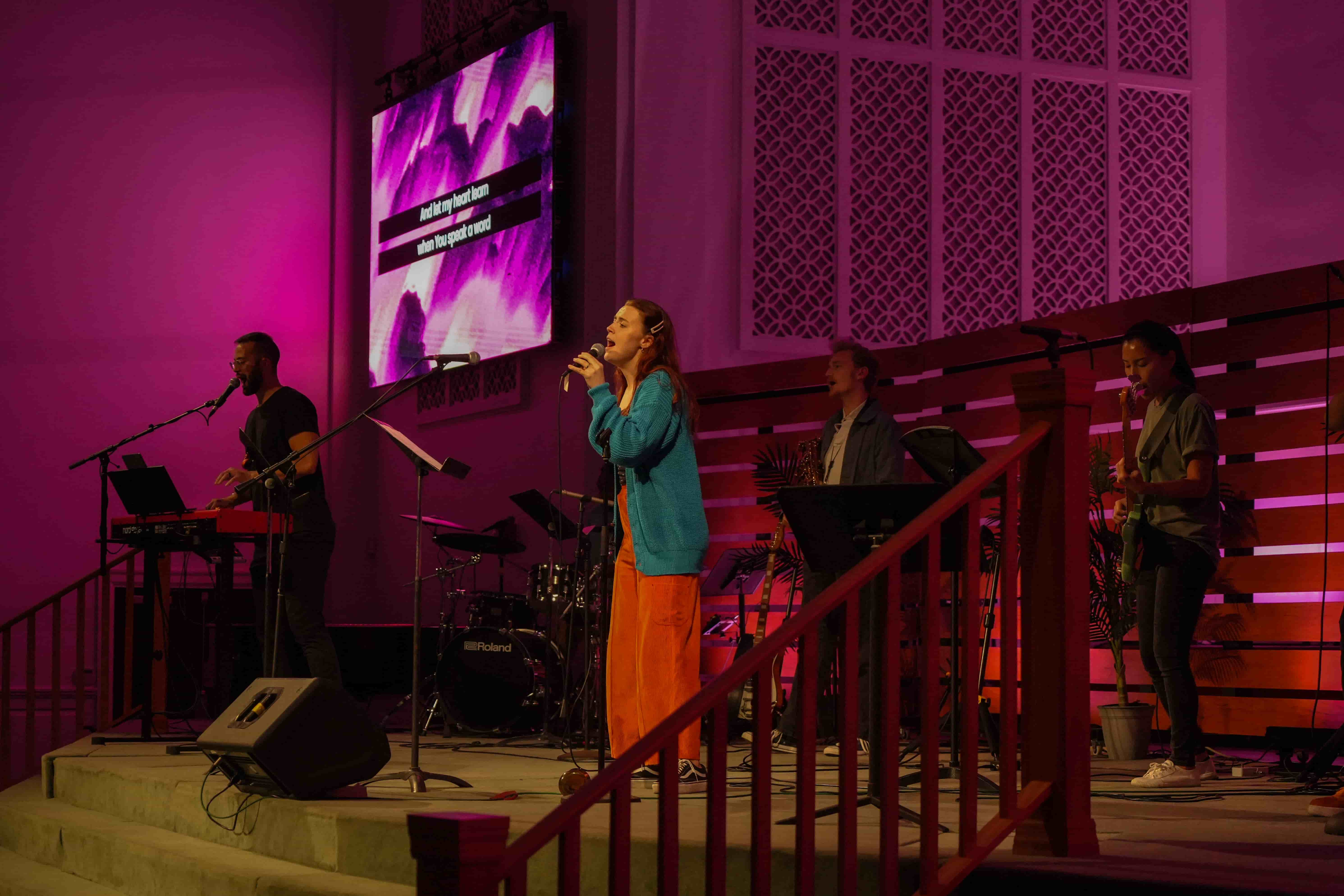 Worship team leading songs on stage